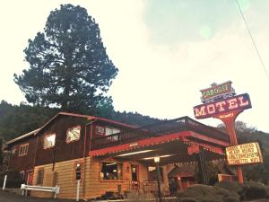 a wooden motel with a sign in front of it at Caboose Motel & Gift Shop in Durango