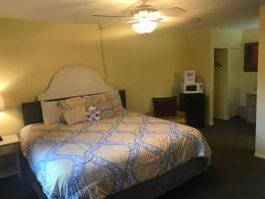 Un dormitorio con una cama con un osito de peluche. en Caboose Motel & Gift Shop, en Durango