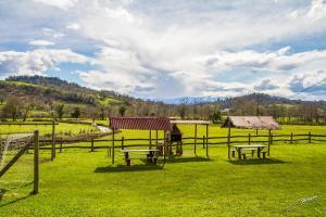 a field with benches and a table and a fence at Casa Rural Peña Careses in Careses