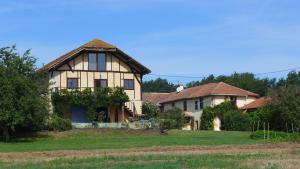 an old house in a field with trees at La Maison de Thelma in Bézues-Bajon