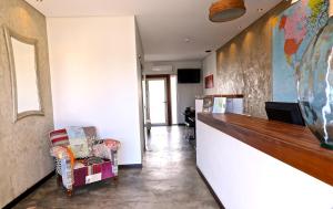 a hallway with a bar and a chair in a room at Lost & Found - Guesthouse & Suites in Albufeira