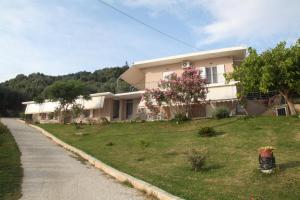 a large house on a hill with a grass yard at Akrothalassia in Ligia