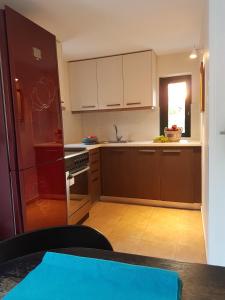 a kitchen with brown cabinets and a refrigerator at Villa Avra in Poros