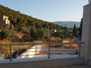 a balcony with a view of a mountain at Villa Avra in Poros