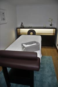 a bedroom with a bed with a black and white mattress at O Casario in Mirandela