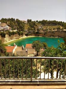 a view of a beach from a balcony at Magdalini in Votsi