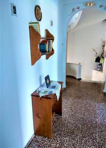 una habitación con una mesa con libros en la pared en Magdalini, en Votsi