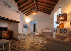 a living room with a couch and a tv at Aleixo's House | Alentejo in Monforte