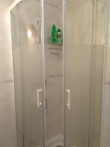 a shower with a glass door in a bathroom at Les Studios proche du Mont Ventoux in Mazan +32 photos