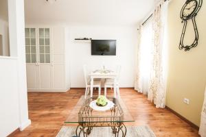 a living room with a table and a tv at Traditional Apartments Vienna TAV - Entire in Vienna