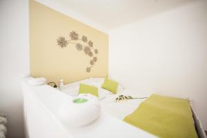 a bedroom with a white bed with yellow pillows at Traditional Apartments Vienna TAV - Entire in Vienna