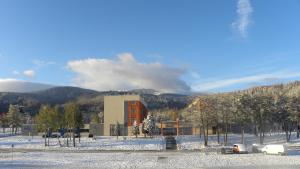 a building in front of a snow covered mountain at Hotel Szyndzielnia in Bielsko-Biala