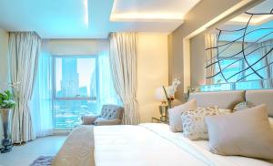 a bedroom with a large bed and a large window at Elite Royal Apartment - Burj Residences Tower 5 in Dubai