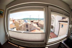 an open window with a view of a city at Fontana in Izola +48 photos