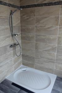 a shower with a white tub in a bathroom at les salines de la turballe in La Turballe +40 photos