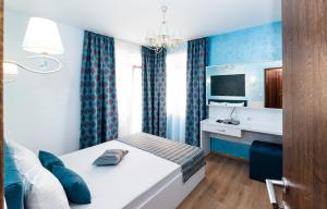 a bedroom with a bed and a desk in it at Stela Apartments in Obzor