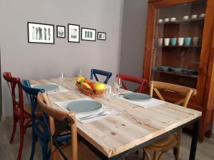 a wooden table with a bowl of fruit on it at Maison Degli Archi in Sorrento