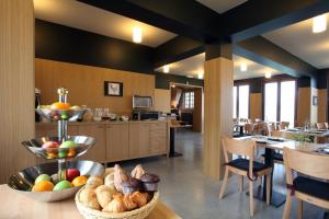 a kitchen with a table with baskets of food on it at 'S Hertogenmolens Hotel in Aarschot +24 photos
