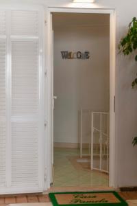 a door to a room with a sign on the wall at Casa Pamela in Capri