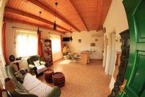 a living room with a couch and a table at Szőlőhegyi házikó - Cottage in the vineyard in Balatonszemes