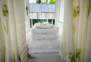 a stack of towels sitting on a window sill at Rye Hill Farm in Hexham +42 photos