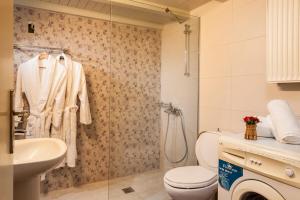 a bathroom with a toilet and a sink and a shower at Filio House in Stalos +10 photos