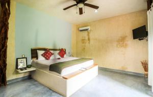 a bedroom with a bed and a ceiling fan at Corazon De Jade Tulum in Tulum