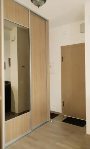 an empty room with a sliding glass door at Miško apartamentai 50m2 in Juodkrantė