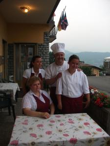 a group of people standing in front of a table at Hotel Poggio d'Oro in Riva di Solto