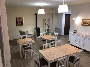 a kitchen with wooden tables and chairs and a stove at Villa Lò in Chieti