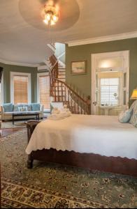 a bedroom with a large bed and a staircase at The Artist House in Key West