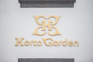 a sign for a hotel garden on the side of a building at Horta Garden in Horta