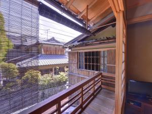a balcony with a view of a building at Ryokan Inakatei in Kyoto