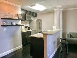 a kitchen with a counter top and a refrigerator at Wine Down Downtown ATL 14J in Atlanta