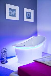 bañera blanca en una habitación con fotos en Loft Suite en Lodz