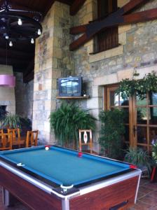 a pool table in front of a building at Hotel La Pradera de Marta in Quintanaentello