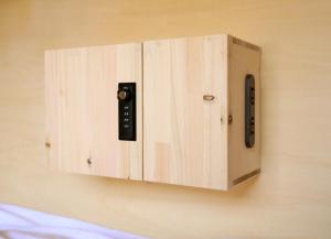 a switch on a wall with a remote control at EN hostel in Kochi