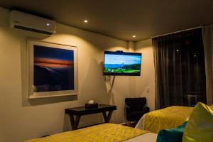 A television and/or entertainment centre at Kabah Boutique Hotel
