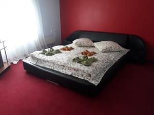 a bedroom with a bed with flowers on it at Apollon in Mukacheve