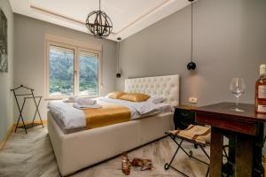 a bedroom with a bed and a desk and a window at Apartments Magic Sea View in Kotor