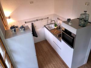 a kitchen with a white refrigerator and a sink at Ferienwohnung Nägler in Erbach