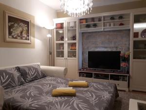 a living room with a couch and a flat screen tv at House Villa Mare in Malinska