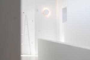 a room with white walls and a white table at Albus Villas in Pyrgos