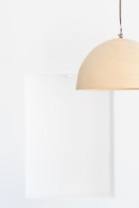 a close up of a white lamp with a wooden shade at Albus Villas in Pyrgos