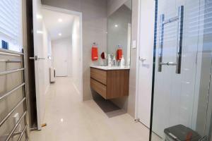 a bathroom with a sink and a shower at Halfmoon Bay Apartment in Auckland