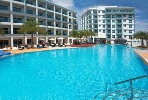 a large swimming pool in front of a building at GrandBlue Condominium 201 in Mae Pim