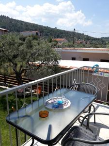 a blue table on a balcony with a view at Filoxenia Apartments in Skala Sotiros