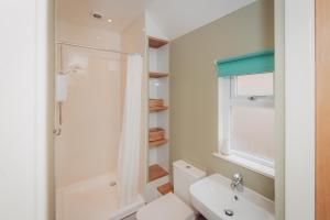 a bathroom with a shower and a toilet and a sink at Firhurst in Aboyne