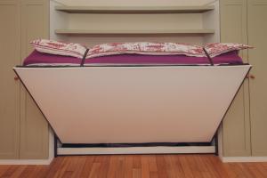 Una cama en un armario con dos almohadas. en Firhurst, en Aboyne