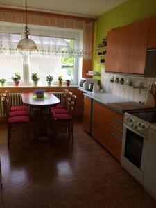 eine Küche mit einem Tisch, Stühlen und einem Tisch sowie eine Küche mit einem Tisch in der Unterkunft Privat Klonga in Smrečany